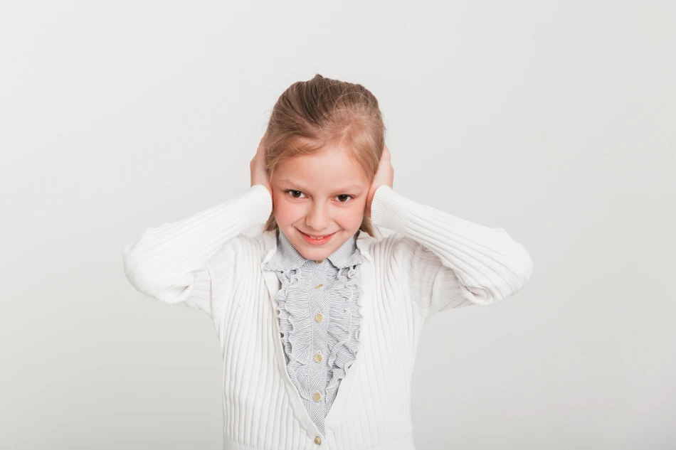 Little girl covering her ears