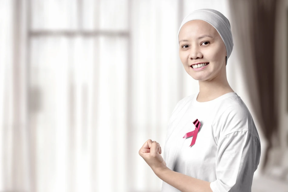 Asian woman in a white shirt with a pink ribbon on the home